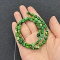 Macro view of oval green imperial jasper beads showing natural mottled stone textures - No.1 Green Pattern