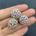 Macro shot of three 18mm handmade woven natural freshwater pearl beads in purple pink - Purple