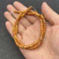 4x8mm orange Emperor stone cylinder beads for DIY jewelry making shown on hand - 4x8mm (49 Pcs/Strand) / Orange-Brown Texture