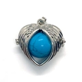 Silver heart wing pendant featuring a round turquoise stone with natural mineral textures - Dark Blue Turquoise