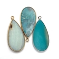 Detail of teardrop natural stone pendants with metal edges and dual jump rings - 21x45mm / Amazonite