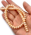 Pink natural freshwater pearls in near-round shape on hand with lustrous finish - 3-4mm 15g / Pink