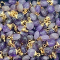 Detailopname van gefacetteerde paarse amethist hangers met vergulde randen in een bulkset - Amethist / 8x14mm