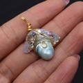 Handmade light blue baroque pearl pendant wrapped in golden wire held in hand - Light Blue Baroque Style (No. 1) / 24x25-27x40mm / Light Blue