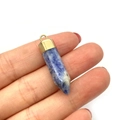 Handheld view of a blue and white sodalite stone cone pendant with a gold metal cap - Lapis Lazuli Texture (No. 5)