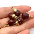 Five teardrop red jasper pendants with gold plated caps held in hand for size visualization - Red Jasper