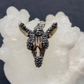 Macro view of crystal encrusted animal head pendant with textured zebra pattern finish - US 2