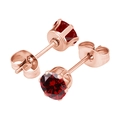 Detail of rose gold six-prong stud earrings featuring a deep red round zircon - 3mm Zirconia / Rose Gold + Garnet Red