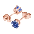 Macro shot of rose gold six-prong stud earrings with dark blue round-cut zircon crystals - 3mm Zirconia / Rose Gold + Royal Blue