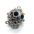 Macro shot of silver owl pendant with black gemstone eyes and red sphere insert - Rainbow Stone