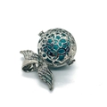 Macro shot of silver star-patterned hollow pendant with turquoise bead and wing charm - 29x31mm / Blue Turquoise