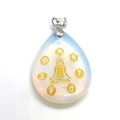 Detail of opal teardrop pendant with gold yoga figure and chakra symbols on white background - Opal
