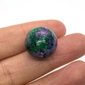Polished 16mm ruby in zoisite round sphere bead held in hand for scale and detail - Ruby Zoisite