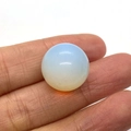 Spherical white opal natural stone bead held between fingers for jewelry DIY projects - Opal