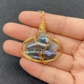 Detail of wire-wrapped pendant with irregular pearls and white crystal stones - Style 1 (Rainbow Baroque Pearl)