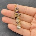 Macro detail of handmade wire-wrapped crystal pendant with colorful baroque pearls - Purple Pearl Mineral Column Gold Wire Style (No. 5)