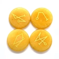 Flat round yellow aventurine stones engraved with golden energetic sigils and runes - Topaz