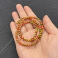 Multicolor natural imperial jasper round beads bracelet shown wrapped around a hand - No.15 (Mixed Color Texture)