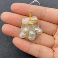 Macro detail of handmade wire-wrapped baroque pearl and crystal pendant in gold finish - Style 4 (No. 4)