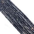 Macro detail of cylinder imperial stone beads with natural black and white marble patterns - Black & White Mottled (No.19)