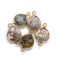 Detail view of five teardrop natural stone pendants with gold metal plated edges and dual loops - 7# Agate