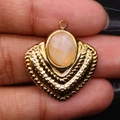 Vintage gold textured pendant with oval light orange gemstone held between fingers - Pink Aventurine / Pendant Only (Without Chain)