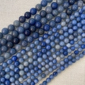 Detailed macro view of natural blue stone beads in various sizes for DIY jewelry making - Blue Aventurine