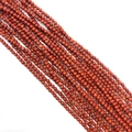 Macro shot of natural red jasper round beads showing stone texture for DIY jewelry - Red Jasper