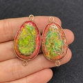 Handheld view of a colorful emperor stone oval connector with gold-plated double loops - Colorful Irregular Texture (No.6)