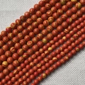 Détail macro des perles rondes à rayures rouges et jaunes pour bijoux personnalisés - Jaune Orangé