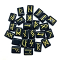Polished black stone Rune set with engraved gold Elder Futhark symbols on white background - Black Agate