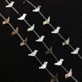 Macro shot of bird-shaped natural shell beads with iridescent luster for DIY jewelry - Black Shell-Bird
