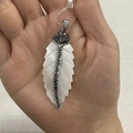 Leaf-shaped natural white shell pendant with rhinestones held in hand for DIY jewelry - No. 2 (25x68mm)