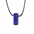Detailaufnahme eines rechteckigen Lapislazuli-Anhängers mit goldfarbenem Pyrit und schwarzer Kordel - Lapislazuli