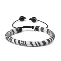 Close-up of bohemian hand-woven bracelet with black and white striped pattern and pull cord - Minimalist Black White Striped Style (FK0247)