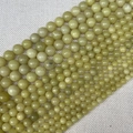 Strands of light green lemon jade round beads showing smooth finish and natural textures - Lemon Jade 4mm