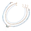 Macro detail of three-layered necklace set featuring blue stone, pearls and butterfly pendant - Light Blue (FN1542)