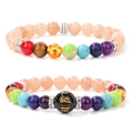 Close-up of beaded bracelets with colorful chakra stones and engraved black agate beads - Angelite