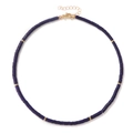 Macro view of blue lapis lazuli cylinder bead necklace with gold spacer discs and clasp - Lapis Lazuli