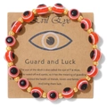 Red Evil Eye beaded bracelet with golden spherical spacers on kraft paper card - Red