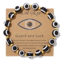 Handcrafted Evil Eye bracelet with black and white beads and gold accents on card - Black and White