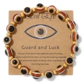 Handmade Evil Eye bead bracelet with 18k gold accents on a craft display card - Brown