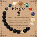 Bracciale zodiaco Vergine con perline nere opache e ciondoli dorati su scheda espositiva - Senza carta / Vergine