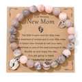 Pink marble bead bracelet with heart and baby feet charms on New Mom gift card - Pink Zebra Jasper