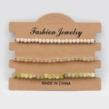 Detailed macro view of three-piece natural stone bead bracelets on brown display card - White Fossil Tea Watermelon Yellow Turquoise