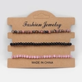 Detailed view of three-piece beaded bracelets on a natural kraft card display - Black Line Rhodonite Black Glass Pink Cat Eye