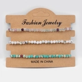 Three-piece natural stone bead bracelet set in purple, white, and teal on card - Fluorite Tree Agate Shoushan Stone
