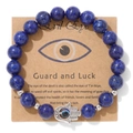 Détail du bracelet Hamsa en perles bleues avec œil maléfique sur carte kraft - Aspect Lapis-Lazuli (CCA181)