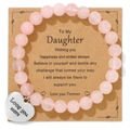 Detailed macro view of pink zebra bead bracelet with heart charm on gift card - Rose Quartz Bracelet (To Daughter Card)