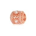 Detailed macro view of hollow rose gold bead charm with intricate vintage metal carvings - Rose Gold